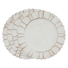 an empty white plate with scalloped edges