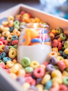 a box filled with lots of cereal and a small candle in it's center