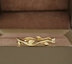 a gold ring sitting on top of a box