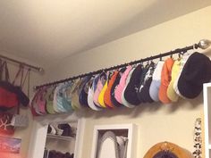 there are many hats hanging on the wall