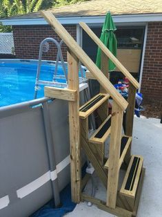 an above ground swimming pool with steps leading to the upper deck and bottom part of the pool