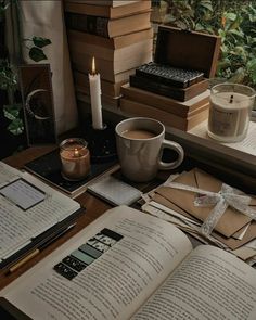 an open book sitting on top of a table next to a cup of coffee