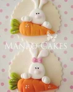 two decorated cookies with bunnies and carrots on them