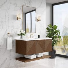 a bathroom with marble walls and flooring next to a large glass door leading outside