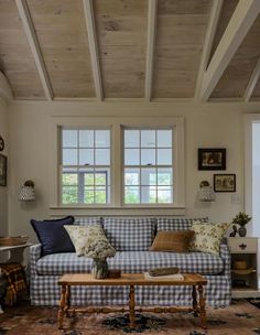 a living room filled with furniture and windows