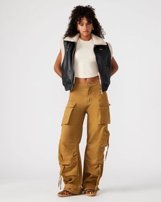 Expertly designed for a structured and voluminous fit, the DUO pant is crafted from midweight cotton twill fabric. With adjustable ankle straps, these wide leg cargo pants offer a versatile silhouette that can be easily customized to your preference. Mid rise cargo pants Zipper fly with shank button closure Two side pockets, two back patch pockets, and five cargo pockets down the legs Bottom 3 cargo pockets feature extended zipper pulls Snap strap at hem to cinch ankles Inseam: 31" 100% cotton H Wide Leg Cargo Pants, Shank Button, Zipper Pulls, Twill Fabric, Bottom Clothes, Ankle Straps, Cotton Twill Fabric, Cargo Pants, Cotton Twill