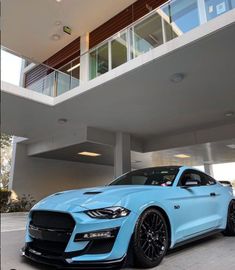 a blue car parked in front of a building