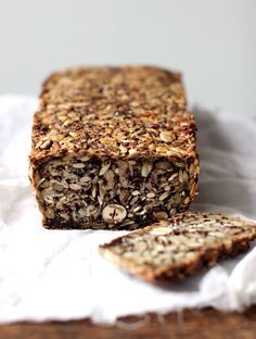 a loaf of granola bread sitting on top of a white napkin