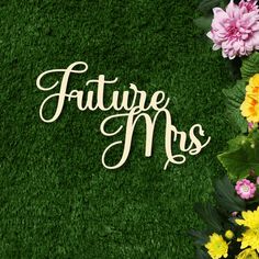 the word'future mrs'is surrounded by flowers and greenery in front of a green wall