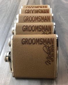 three groomsman canisters sitting on top of a wooden table