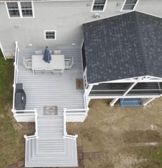 an aerial view of a house with a deck and patio