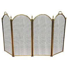 three - panel gold metal fireplace screen