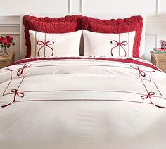 a red and white bed with bows on it