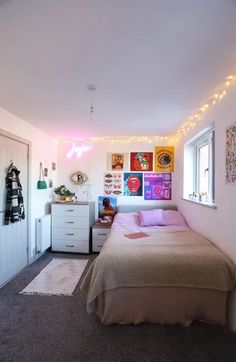 a bed room with a neatly made bed and lots of lights