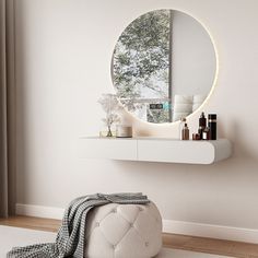 a round mirror sitting on top of a white shelf