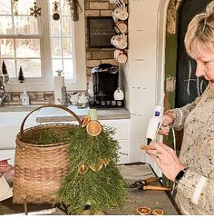 a woman is making christmas decorations in her kitchen