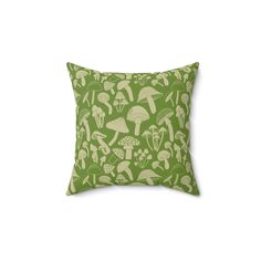 a green pillow with mushrooms on it