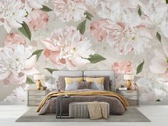 a bedroom with pink and white flowers on the wall, bedding and nightstands