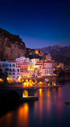 a city lit up at night by the water