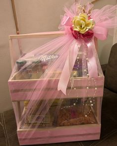 a pink gift box filled with snacks and candy