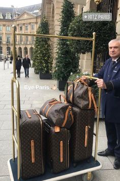 a man standing next to luggage on a cart