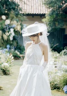 a woman in a white wedding dress and veil