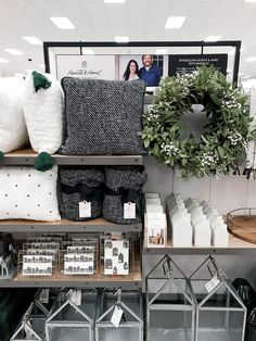 the shelves are filled with pillows, blankets and other decorative items for sale in a store