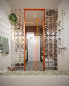 a bathroom with an orange frame and glass doors