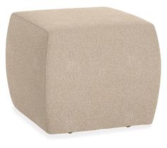 a beige ottoman that is sitting on top of a white floor and it's cover