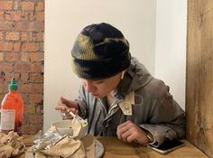 a person sitting at a table eating food