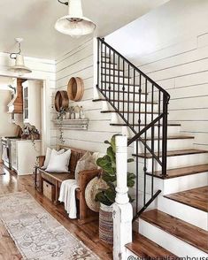 a living room filled with furniture and a stair case next to a wooden flooring