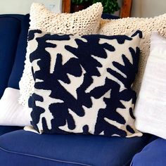 a blue couch with two pillows on it