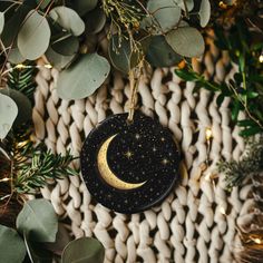 a ceramic ornament with a crescent and stars hanging from it's side