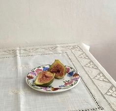 a plate with two pieces of figurines on it sitting on a tablecloth