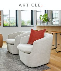 a living room filled with furniture and lots of windows