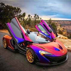 a purple and orange sports car with open doors