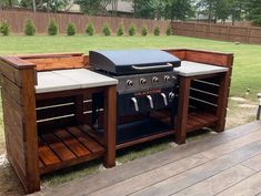 an outdoor grill built into the side of a wooden deck