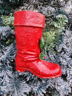 a red boot ornament hanging from a christmas tree