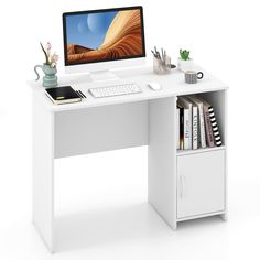 a computer desk with a monitor, keyboard and books on it in front of a white background