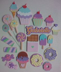 there are many cupcakes and donuts on the table with name stickers