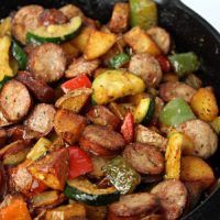 a pan filled with meat and vegetables on top of a stove