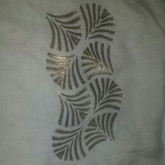 a white shirt with silver sequins on it