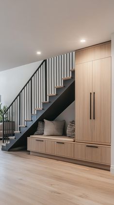 the stairs are built into the wall next to the storage area in the living room