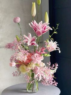 a vase filled with pink and white flowers