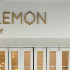 the front entrance to a building with white doors and gold lettering that reads lemon center