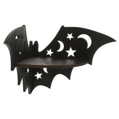 a bat shaped shelf with stars and crescents on it