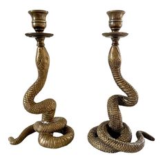 two metal candlesticks with snakes on them