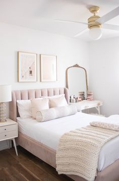 a bedroom with white walls and wooden floors