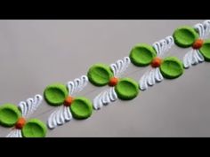 green and white paper flowers on a string