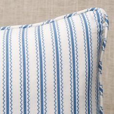 a blue and white striped pillow sitting on top of a couch